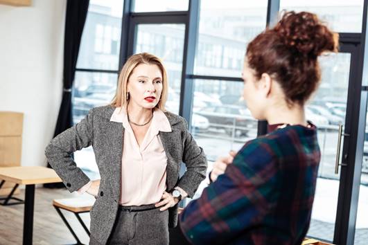 Women talking down to female employee - Whistleblower Protection